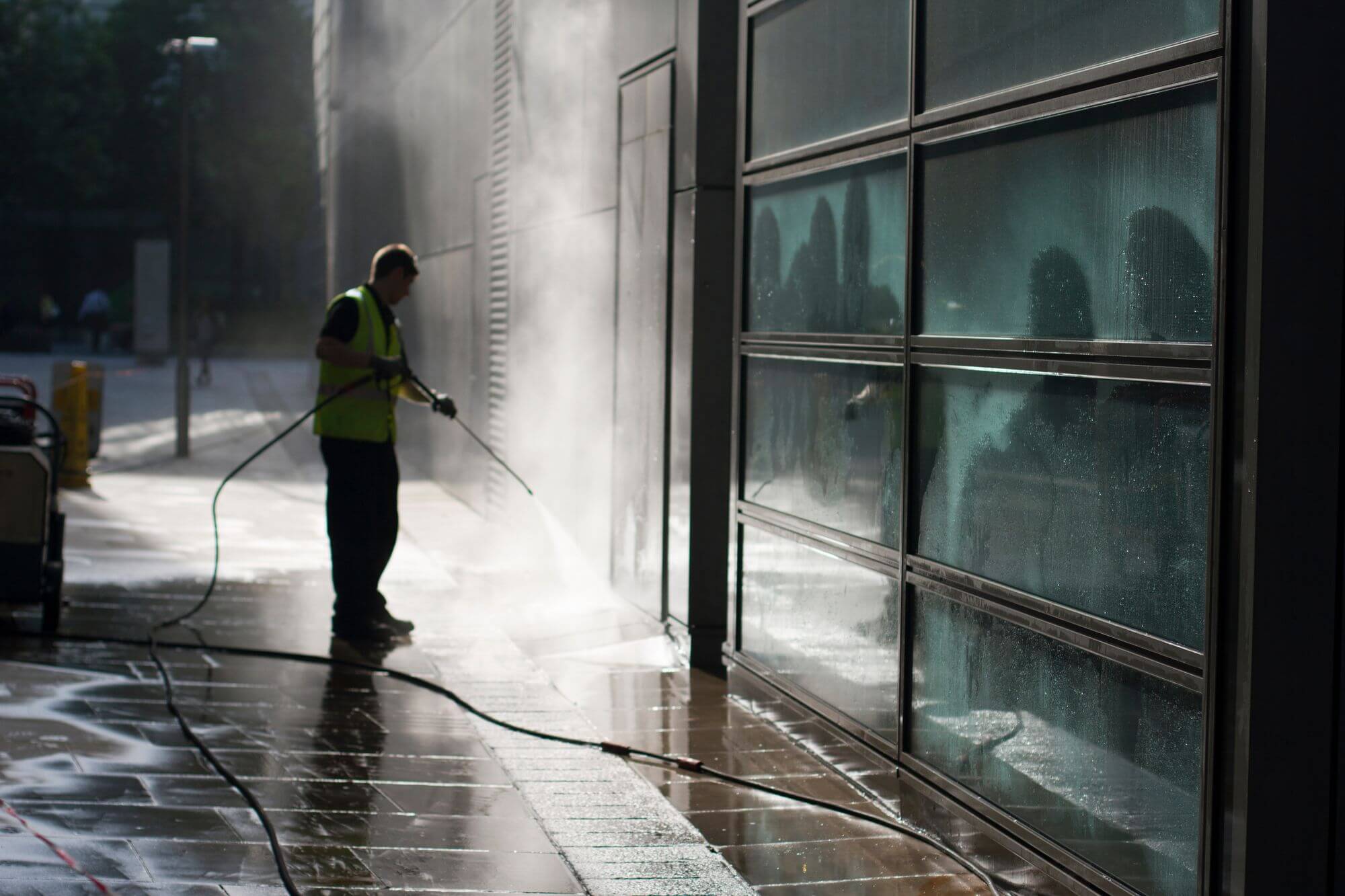 Commercial exterior soft washing removing organic growth from a building facade